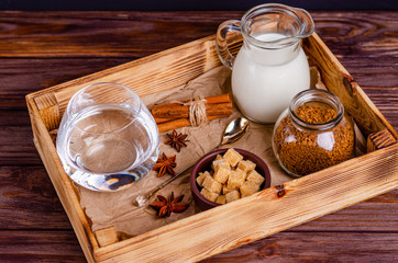 Ingredients for Dalgon coffee in a box on a wooden background.