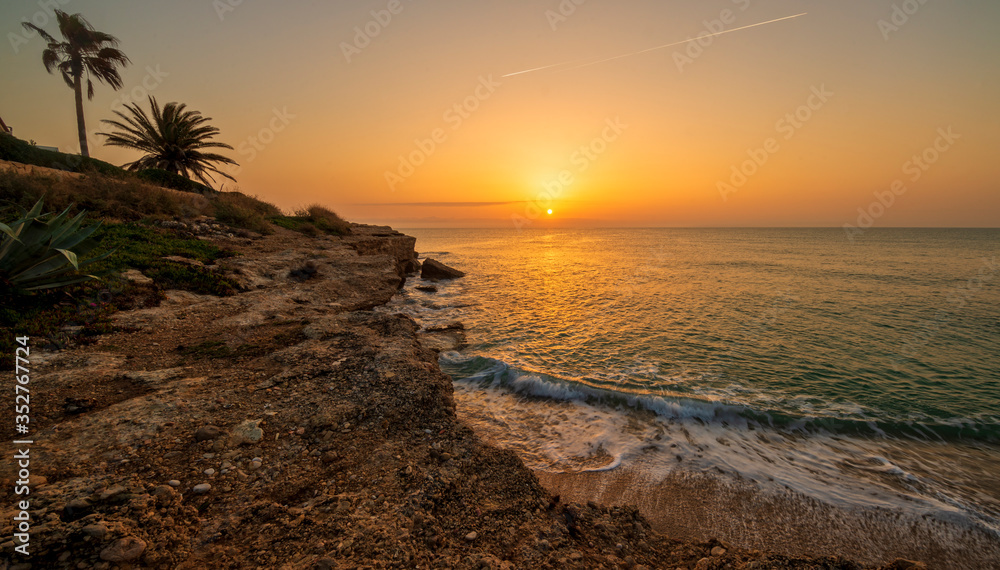 Wall mural Sunrise in Oropesa del Mar on the orange blossom coast