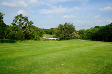 Beautiful golf course in a sunny day. Background evening golf course has sunlight shining down. Golf course in the countryside.