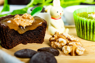Chocolate Brownie Cake in Paper Cups Decorated with components for making cakes placed on wooden floors
