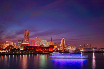 Fototapeta na wymiar The skyline view of Yokohama harbour at night. Yokohama Port serves 38000 ships a year.