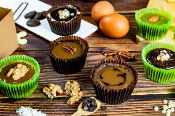 Chocolate Brownie Cake in Paper Cups Decorated with components for making cakes placed on wooden floors