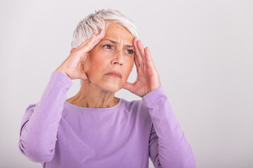 Attack of the monster migraine. Sinus pain. Unhappy Retired Senior Woman holding her head with pain...