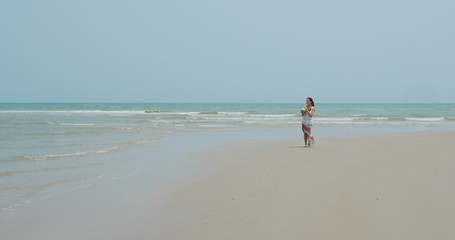 Woman walk in the beach