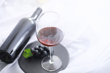 Glass with grape red semi-dry wine. Valentine's day concept background. Gift for the holiday. Sweet sparkling wine.