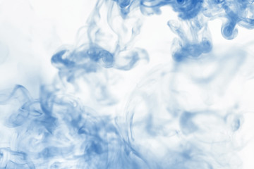 Puffs of paint in water. The dissolution of the dye in water. Water pollution. Concept art creativity.