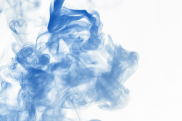 Puffs of paint in water. The dissolution of the dye in water. Water pollution. Concept art creativity.