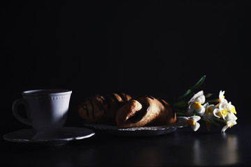 French breakfast on the table. Coffee croissant with chocolate and a decanter with cream. Fresh...