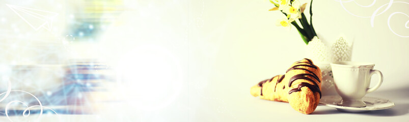 French breakfast on the table. Coffee croissant with chocolate and a decanter with cream. Fresh pastries and decaffeinated coffee.