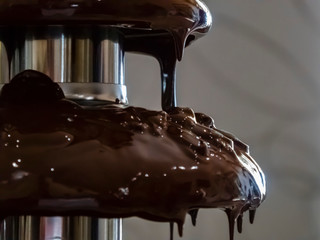 Chocolate Fondue Fountain. isolation on a colored background