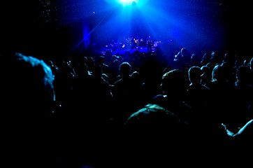 Fototapeta na wymiar People watching a concert in a hall or club