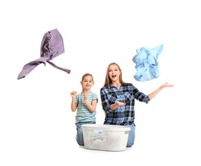 Happy mother and little daughter with laundry on white background