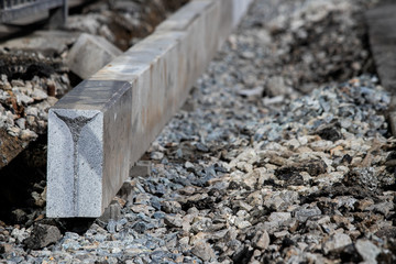Setting road border before laying asphalt. Reconstruction of the sidewalk and replacement of old curbs. Road infrastructure repair