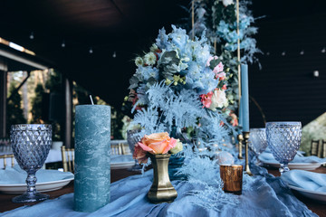 Banquet table setting and decoration. Cutlery on the table. Blue interior decoration.
