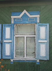 Window with carved wooden shutters in a Russian house