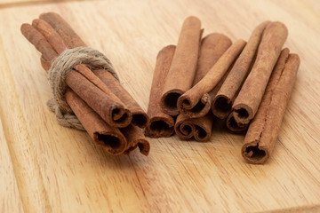 Cinnamon sticks isolated on wooden table background.