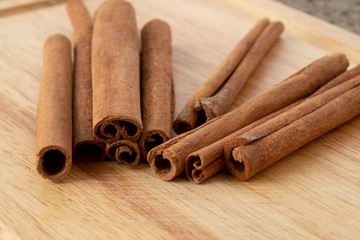 Cinnamon sticks isolated on wooden table background.