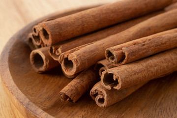 Cinnamon sticks isolated on wooden table background.