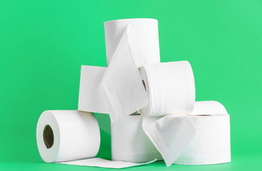 Rolls of toilet paper on color background