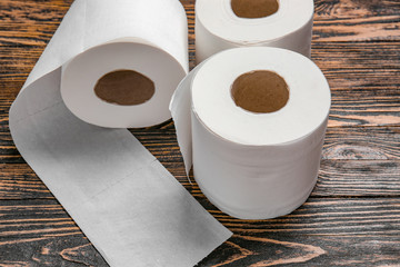 Rolls of toilet paper on wooden background