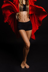 Young and beautiful girl dancer posing in studio.