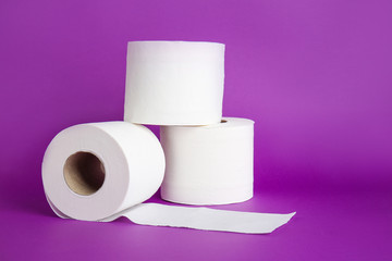 Rolls of toilet paper on color background