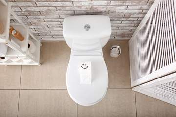 Interior of bathroom with toilet bowl, top view
