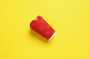 Takeaway cup for drink on color background