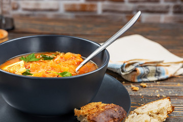 Red soup with vegetables and meat, tasty, traditional Ukrainian borsch, close-up, shallow depth of field, selective focus. Healthy Organic Homemade Food Concept