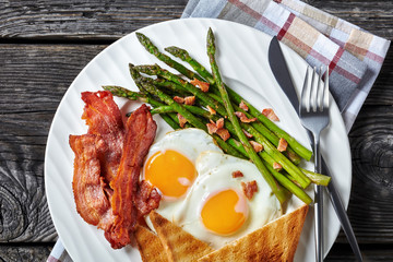 fried eggs, crispy bacon, toast, asparagus spears
