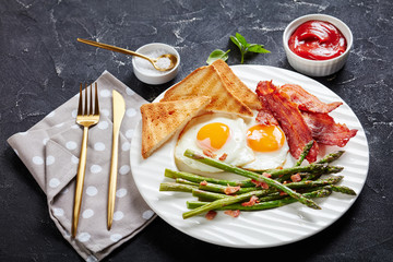 fried eggs, crispy bacon, toast, asparagus spears