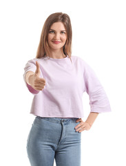 Beautiful young woman showing thumb-up gesture on white background