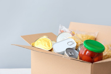 Box with donations on light background