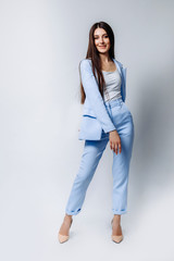 Fototapeta premium an Indian business woman with a straight hairstyle in a formal blue pantsuit, beige high-heeled shoes