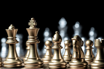 gold against silver chess pieces team on chess board, business strategy concept