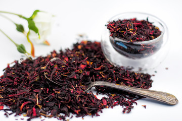 Dry Egyptian Red tea herbs with flowers on white background. Selective focus.