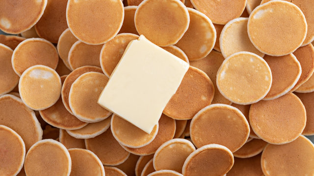 tiny cereal pancakes with piece of butter, pancakes background