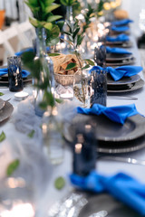 Close up of banquet table with beautiful decorations and serving. Professional approach for decorating. Stylish details.
