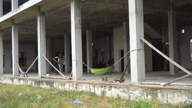 Low Wage Slave Labor in Construction - Hamock at Large Scale Construction Site