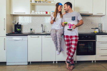 Young couple enjoying a morning coffee at home.