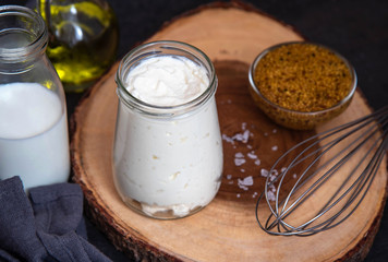 Vegetarian mayonnaise. Ingredients for mayonnaise oil, milk and mustard. Homemade mayonnaise