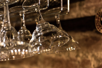 Glass goblets in a bar. Glare and light.
