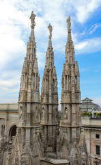 Fototapeta premium Three sculptures on the roof of the Duomo