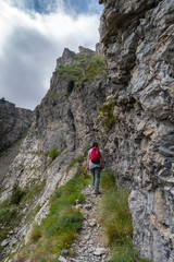 Female hiker on mountain pathway, Ligurian Alps, Italy