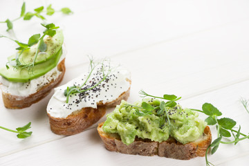 Healthy sandwiches with avocado , cream cheese and micro green. Vegan sandwiches, vegan food, healthy eating. Template with space for text , white background