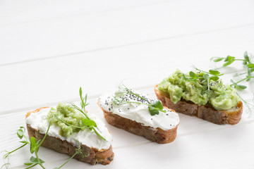 Healthy sandwiches with avocado , cream cheese and micro green. Vegan sandwiches, vegan food, healthy eating. Template with space for text , white background