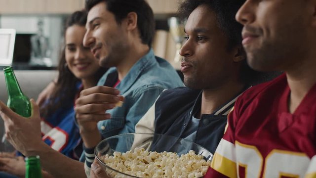 Handheld video of friends watching something funny and eating popcorn. Shot with RED helium camera in 8K