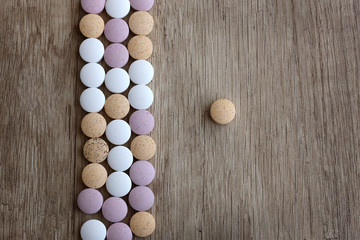 Medical tablets on a wooden background.Medicines on a wooden background.Flat lay, blur