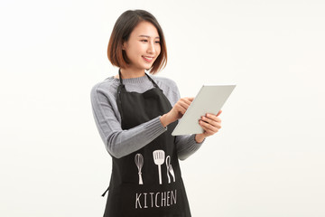 Naklejka premium Beautiful female owner using digital tablet on white
