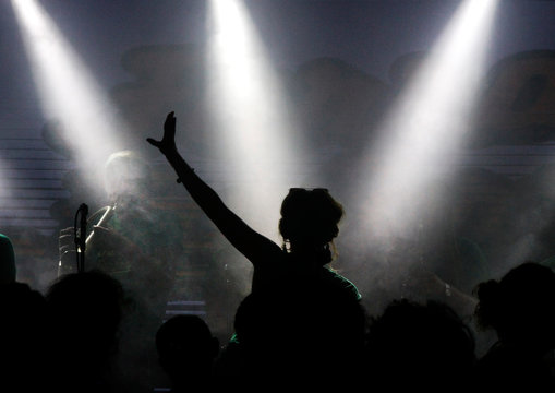 Silhouette Of An Audience Member With Spotlights In The Background